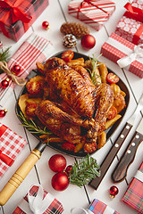 Image showing Roasted whole chicken or turkey served in iron pan with Christmas decoration