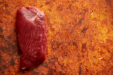 Image showing Piece of raw fresh beef steak placed on rusty background