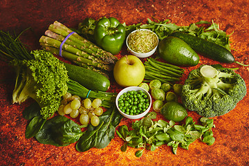 Image showing Fresh green vegetables and fruits assortment placed on a rusty metal