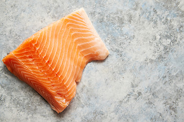 Image showing Raw fresh salmon meat placed on gray stone background