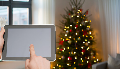 Image showing close up of male hands with tablet pc on christmas