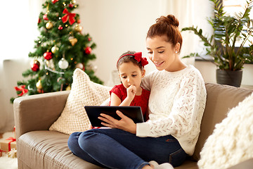 Image showing mother and daughter with tablet pc on christmas