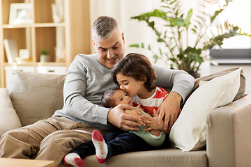 Image showing happy father with preteen and baby son at home