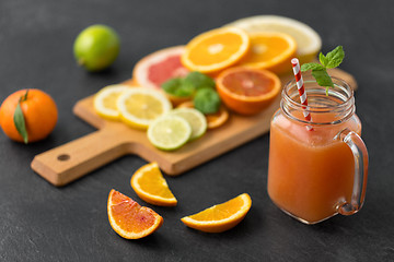 Image showing mason jar glass of fruit juice on slate table top