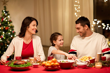 Image showing happy family having christmas dinner at home