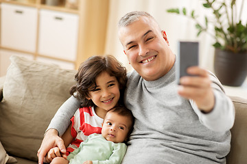 Image showing happy father with sons taking selfie at home