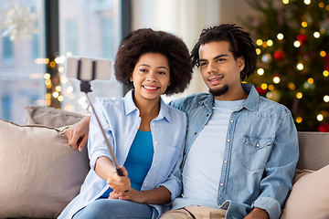 Image showing couple with smartphone taking selfie on christmas