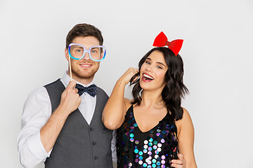 Image showing happy couple with party props having fun