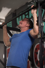 Image showing man doing pull ups