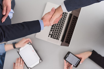 Image showing cloasing the deal in modern office interior top view