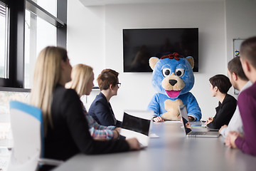 Image showing boss dresed as bear having fun with business people in trendy of