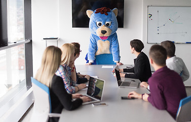 Image showing boss dresed as bear having fun with business people in trendy of