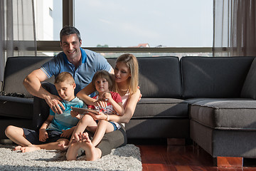 Image showing happy young couple spending time with kids