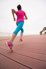 Image showing woman busy running on the promenade