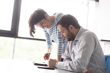 Image showing Two Business People Working With Tablet in startup office