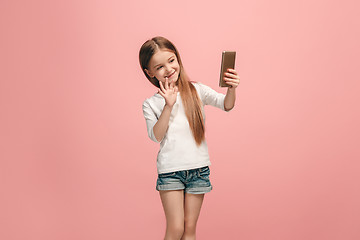 Image showing The happy teen girl making selfie photo by mobile phone