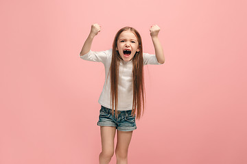 Image showing Portrait of angry teen girl on a pink studio background