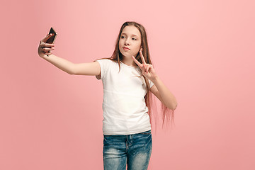 Image showing The happy teen girl making selfie photo by mobile phone