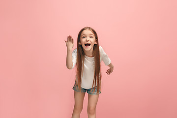 Image showing Beautiful female half-length portrait on pink studio backgroud. The young emotional teen girl