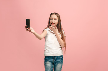 Image showing The happy teen girl making selfie photo by mobile phone