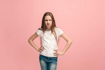 Image showing Portrait of angry teen girl on a pink studio background