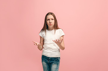 Image showing Beautiful female half-length portrait on pink studio backgroud. The young emotional teen girl