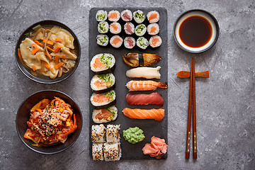 Image showing Various kinds of sushi placed on black stone board