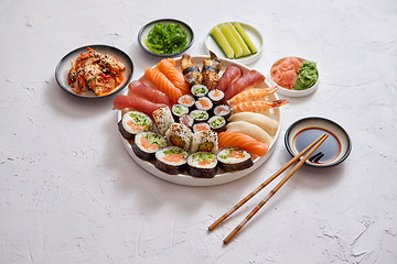 Image showing Various sushi rolls placed on round ceramic plate