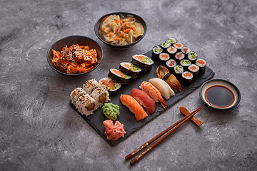 Image showing Various kinds of sushi placed on black stone board