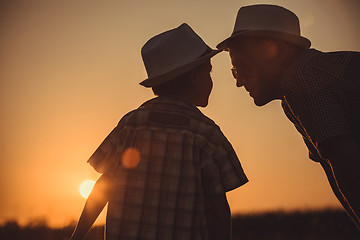 Image showing Father and son playing in the park at the sunset time.