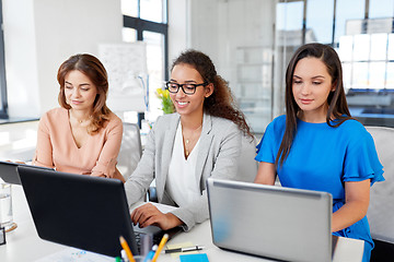 Image showing businesswomen with tablet pc and laptops at office