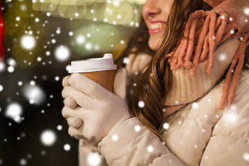 Image showing happy woman with coffee over christmas lights