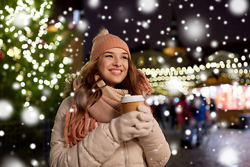 Image showing happy young woman with coffee at christmas market