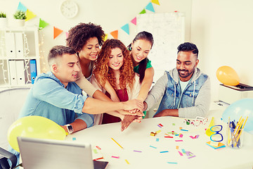 Image showing happy business team at office party holding hands