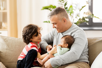 Image showing happy father with preteen and baby son at home