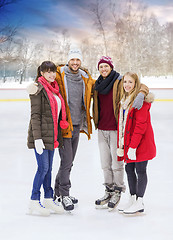 Image showing happy friends on outdoor skating rink