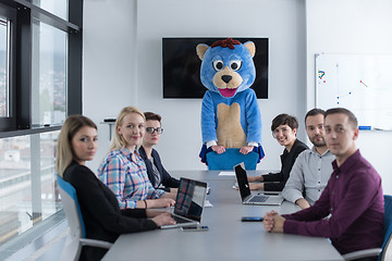 Image showing boss dresed as bear having fun with business people in trendy of