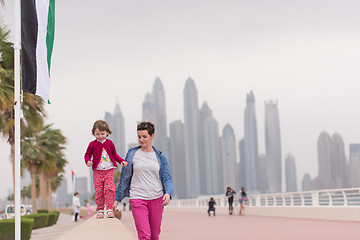 Image showing mother and cute little girl on the promenade