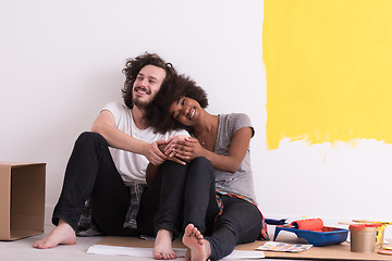 Image showing young multiethnic couple relaxing after painting