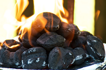 Image showing Flaming BBQ briquettes at eye level