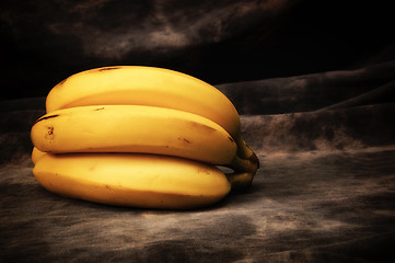 Image showing bunch of ripe yellow bananas on gray studio backdrop