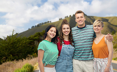 Image showing happy friends hugging over big sur hills and road