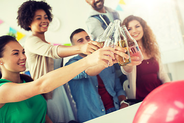 Image showing happy team with drinks celebrating at office party