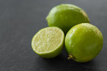 Image showing close up of limes on slate table top