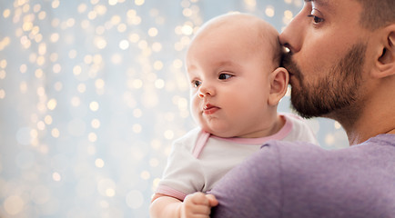 Image showing close up of father kissing little baby daughter