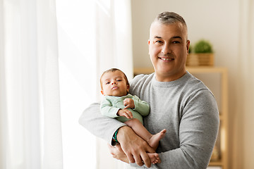 Image showing happy father holding with little baby son at home