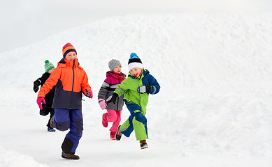 Image showing happy little kids running outdoors in winter