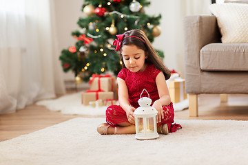 Image showing little girl with lantern at home on christmas