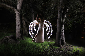 Image showing Girl Light Painted in the Desert Under the Night Sky