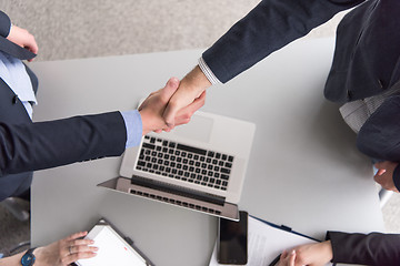 Image showing cloasing the deal in modern office interior top view